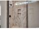 Modern shower showcasing gorgeous marble tile design and contemporary fixtures with frameless shower doors at 404 Plantation Oaks Dr., Myrtle Beach, SC 29579