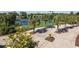 An outdoor tennis court surrounded by palm trees, landscaping, and seating at 404 Plantation Oaks Dr., Myrtle Beach, SC 29579