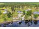 Waterfront property with private beach, a boat dock, and home with large yard surrounded by trees at 4074 Center Rd., Georgetown, SC 29440