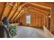 Unfinished attic space with wood beams, a window, and ample room for storage or renovation at 4074 Center Rd., Georgetown, SC 29440