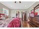 Well-lit bedroom with hardwood floors, and a window with plantation shutters at 4074 Center Rd., Georgetown, SC 29440