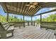View from inside a wooden dock on a wooden floor with wooden benches to enjoy the lake at 4074 Center Rd., Georgetown, SC 29440