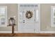 Welcoming entryway featuring a decorative wreath, hardwood floors, and stylish decor at 4074 Center Rd., Georgetown, SC 29440