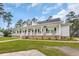 Charming single-story home with a spacious front porch, beautiful landscaping, and inviting curb appeal at 4074 Center Rd., Georgetown, SC 29440