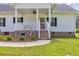 View of the front porch, complete with patriotic decorations and room for outdoor furniture at 4074 Center Rd., Georgetown, SC 29440