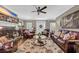 Inviting living room with leather furniture, a fireplace, detailed rug, and a ceiling fan at 4074 Center Rd., Georgetown, SC 29440