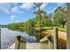Stunning waterfront view with a private dock and a sandy beach area; perfect for relaxation and enjoying the outdoors at 4074 Center Rd., Georgetown, SC 29440