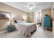 Bright bedroom includes a desk, a ceiling fan and colorful art at 4355 Willoughby Ln. # 401, Myrtle Beach, SC 29577