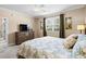 This is a bedroom with a dresser and tv and a window at 4355 Willoughby Ln. # 401, Myrtle Beach, SC 29577