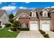 Charming townhome featuring brick accents, manicured landscaping, and two-car garages at 4355 Willoughby Ln. # 401, Myrtle Beach, SC 29577