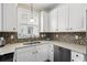 This lovely kitchen features stainless appliances, gorgeous backsplash, and modern countertops at 4355 Willoughby Ln. # 401, Myrtle Beach, SC 29577