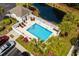 Aerial view of a community pool area with lounge chairs, a pool house, and lush landscaping at 4355 Willoughby Ln. # 401, Myrtle Beach, SC 29577