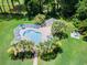 Aerial view of a community pool with palm trees, lounge chairs, and shaded picnic area at 4737 Wild Iris Dr. # 203, Myrtle Beach, SC 29577
