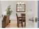 View of a wood dining set and a mirror through a doorway connecting the living room and dining area at 4737 Wild Iris Dr. # 203, Myrtle Beach, SC 29577