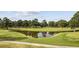 Picturesque golf course view with pond and lush greenery, perfect for relaxing days outdoors at 4737 Wild Iris Dr. # 203, Myrtle Beach, SC 29577
