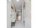 Bright hallway with white wainscoting, bench seat, and doorway to the open concept living area at 4737 Wild Iris Dr. # 203, Myrtle Beach, SC 29577