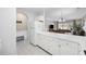 Bright kitchen with white cabinetry and a large counter overlooking the living and dining areas at 4737 Wild Iris Dr. # 203, Myrtle Beach, SC 29577