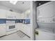 Efficient kitchen with white appliances and a stackable washer-dryer for convenience at 4737 Wild Iris Dr. # 203, Myrtle Beach, SC 29577