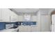 White kitchen with a window and colorful shell-themed window dressing at 4737 Wild Iris Dr. # 203, Myrtle Beach, SC 29577