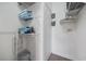 Well-organized laundry area with shelving, folded towels, ironing board, and other accessories at 4737 Wild Iris Dr. # 203, Myrtle Beach, SC 29577