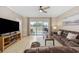 Cozy living room with plush couches, modern entertainment center, and sliders to the outdoor patio at 4737 Wild Iris Dr. # 203, Myrtle Beach, SC 29577