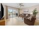 Comfortable living room featuring wood floors, large sliding glass doors to patio and neutral decor at 4737 Wild Iris Dr. # 203, Myrtle Beach, SC 29577