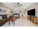 Comfortable open concept living room and dining area, wood floors, large TV and seating at 4737 Wild Iris Dr. # 203, Myrtle Beach, SC 29577