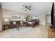 Inviting living room with wood floors, brown sofas, open to kitchen with dining area at 4737 Wild Iris Dr. # 203, Myrtle Beach, SC 29577