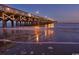 Scenic view of a wooden pier at twilight reflecting lights over the water at 4737 Wild Iris Dr. # 203, Myrtle Beach, SC 29577