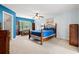 Cozy bedroom featuring a wooden bed frame, ceiling fan, and a comfortable seating area by the window at 480 Dandelion Ln., Myrtle Beach, SC 29579