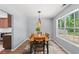 Comfortable dining room featuring wood table with six chairs, decorative chandelier, and window with natural light at 480 Dandelion Ln., Myrtle Beach, SC 29579