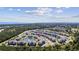 Wide aerial shot showcasing the condo complex with lush surroundings and a view of the distant ocean at 4828 Magnolia Lakes Dr. # 404, Myrtle Beach, SC 29577