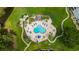 Aerial view of a community pool area with many blue lounge chairs and manicured grounds at 4828 Magnolia Lakes Dr. # 404, Myrtle Beach, SC 29577