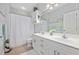 Bathroom featuring double sink vanity, framed mirror, and tub with white shower curtain at 4828 Magnolia Lakes Dr. # 404, Myrtle Beach, SC 29577