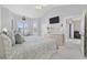 Airy bedroom with vaulted ceilings, TV, and view of the en suite bathroom at 4828 Magnolia Lakes Dr. # 404, Myrtle Beach, SC 29577