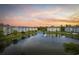 Scenic view of lakeside apartments at sunset with water fountain at 4828 Magnolia Lakes Dr. # 404, Myrtle Beach, SC 29577