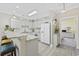 Cozy kitchen with white cabinets, granite countertops, and modern appliances near adjacent breakfast bar and bedroom entrance at 4828 Magnolia Lakes Dr. # 404, Myrtle Beach, SC 29577