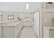 Clean kitchen with white cabinetry, granite counters, stainless steel appliances, and open shelving near dining area at 4828 Magnolia Lakes Dr. # 404, Myrtle Beach, SC 29577