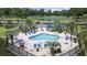 Aerial view of neighborhood pool featuring palm trees and lounge chairs at 4828 Magnolia Lakes Dr. # 404, Myrtle Beach, SC 29577