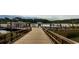 A view of a boat dock that is surrounded by water and greenery, under a partly cloudy sky at 489 Blissful Ln., Little River, SC 29566