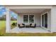 Covered patio with wicker furniture, offering a relaxing outdoor living space at 489 Blissful Ln., Little River, SC 29566
