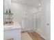Bright bathroom with double sinks, white cabinets, framed shower, and modern fixtures at 493 Blissful Ln., Little River, SC 29566