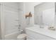 Clean bathroom featuring white cabinets, a bathtub, and a modern design at 493 Blissful Ln., Little River, SC 29566
