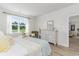 Bedroom with neutral tones, dresser, mirror, and view to the outside at 493 Blissful Ln., Little River, SC 29566