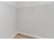 Empty walk-in closet features wire shelving and neutral-toned walls and flooring at 493 Blissful Ln., Little River, SC 29566