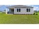 Charming home exterior with gray siding, white trim, and a well-manicured lawn at 493 Blissful Ln., Little River, SC 29566