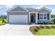 Charming single-Gathering home features a two-car garage and landscaped front yard at 493 Blissful Ln., Little River, SC 29566