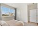 Well-lit bedroom with a large window, neutral decor, and inviting atmosphere, complemented by a view of the outdoors at 497 Blissful Ln., Little River, SC 29566