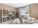 Relaxing room with decorative shelves, a plush sofa, and a large window, creating a peaceful and inviting space at 497 Blissful Ln., Little River, SC 29566