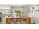 Bright dining area with large windows, a wooden table and a view to the backyard at 497 Blissful Ln., Little River, SC 29566